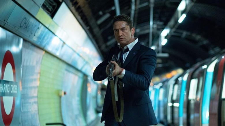 Mike Banning holding a machine gun in a London subway in London Has Fallen