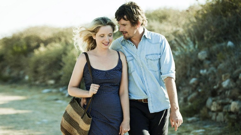 Celine and Jesse walk and smile in Greece at midnight