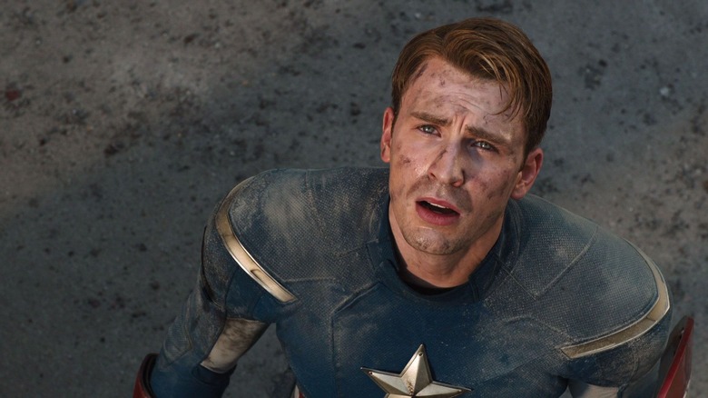 Captain America, scraped up, looking up at the sky, worried in The Avengers