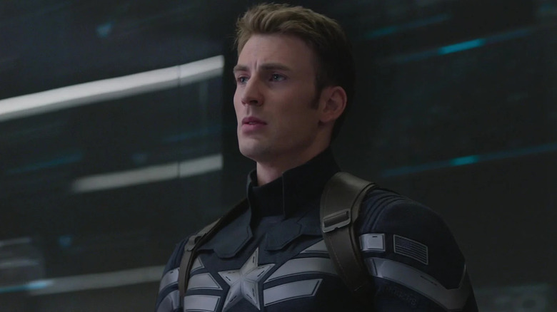 Captain America, looking stern in a new, dark blue costume in Captain America: The Winter Soldier