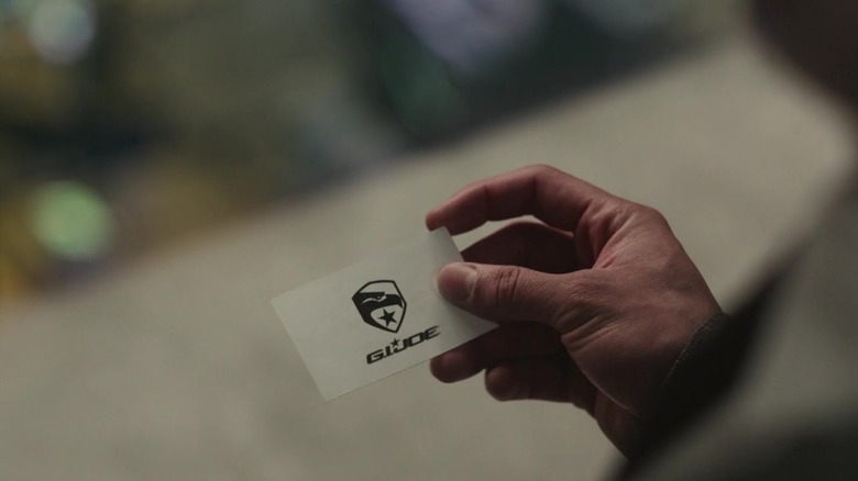 Anthony Ramos as Noah Diaz holding the G.I. Joe card at the end of Transformers: Rise of the Beasts