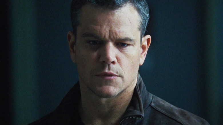 Matt Damon as Jason Bourne stands in shadow in Jason Bourne