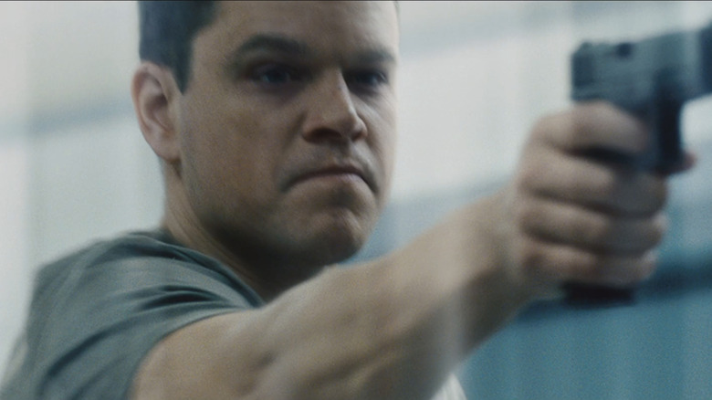 Matt Damon as Jason Bourne aims a handgun in Jason Bourne