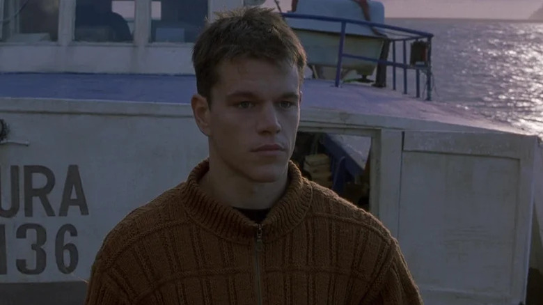 Matt Damon as Jason Bourne stands on a boat in The Bourne Identity