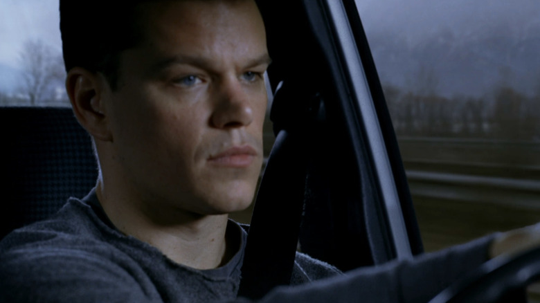 Matt Damon as Jason Bourne drives a car in The Bourne Supremacy