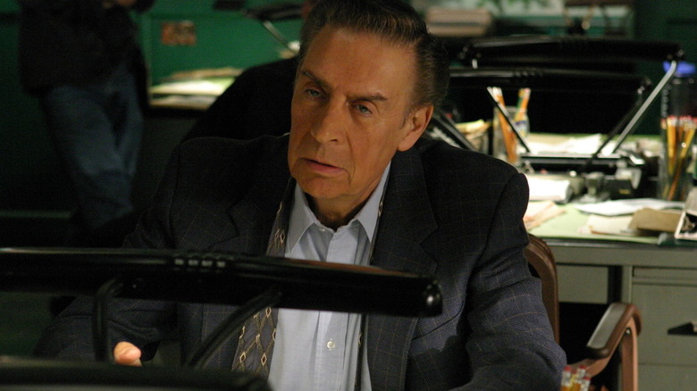 Detective Briscoe at his desk in an episode of Law & Order.