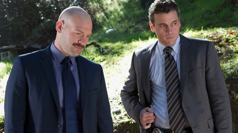 Detectives Jeruszalski and Winters, outdoors in a park, looking at something terrible. A scene from Law & Order: LA.