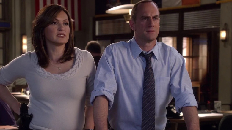 Benson and Stalber at the police station. Benson is in a stylish, understated sweater, Stabler has his hands on a table. From Law & Order: Special Victims Unit.