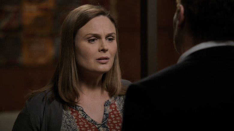 Emily Deschanel's Temperance Brennan looks  troubled as she talks to a man with his back to the camera in Bones