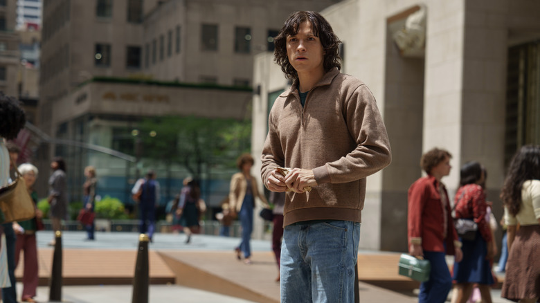 Tom Holland stands in Rockefeller Center in The Crowded Room