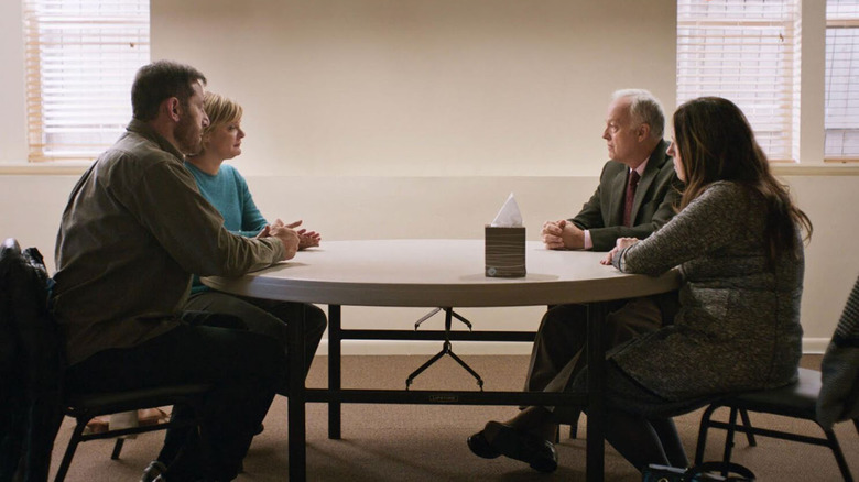two women and two men sitting across from one another at a round table
