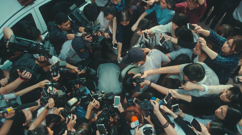 the world between us mr and mrs li surrounded by reporters