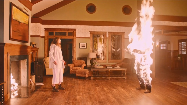 toni collette watching gabriel byrne's body burn in a living room in the movie hereditary
