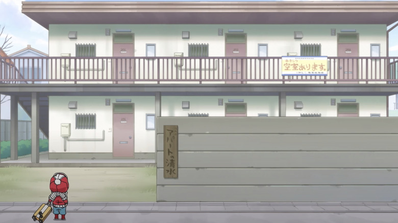 Kotaro in front of the apartment building