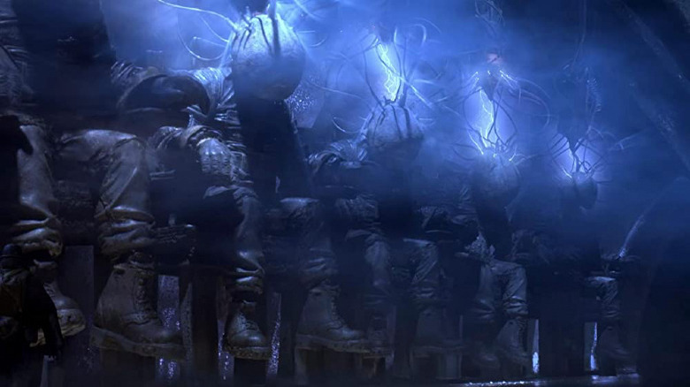 Faceless figures being electrocuted in Mad God