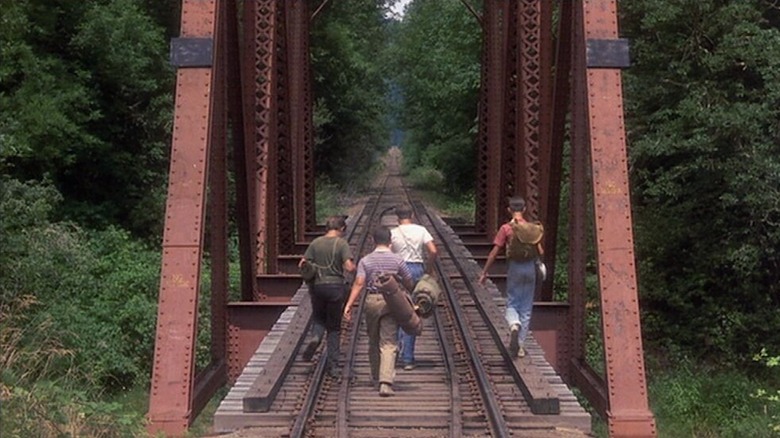 The Stand By Me kids walk the tracks
