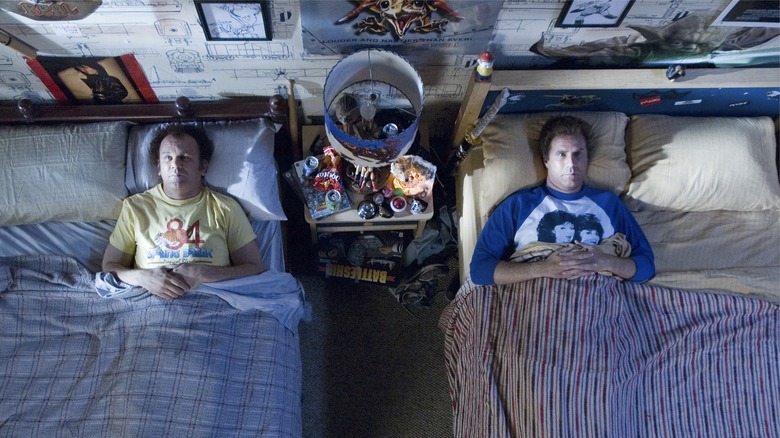 john c reilly and will ferrell laying in two beds next to one another in the movie step brothers
