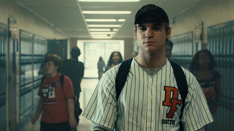 Boy wearing jersey, school hallway