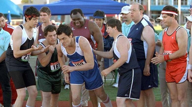 a group of runners hyping up a man about to start a race