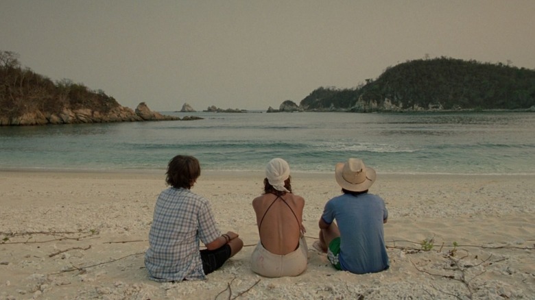 Trio sits on beach