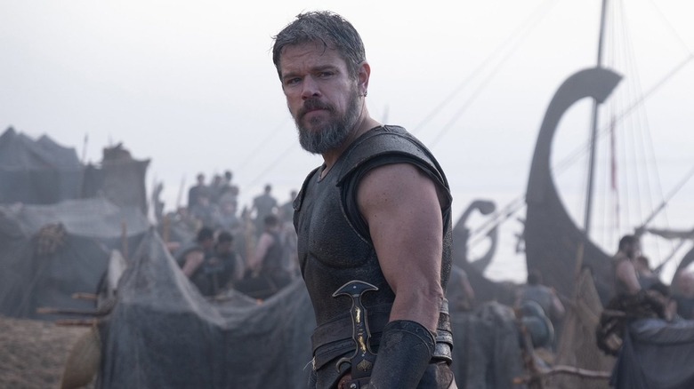 Matt Damon as Odysseus standing by his men at the boats in The Odyssey