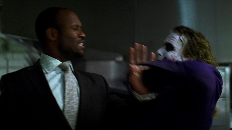 Heath Ledger's Joker grabs Charles Jarman's henchman in The Dark Knight.jpg