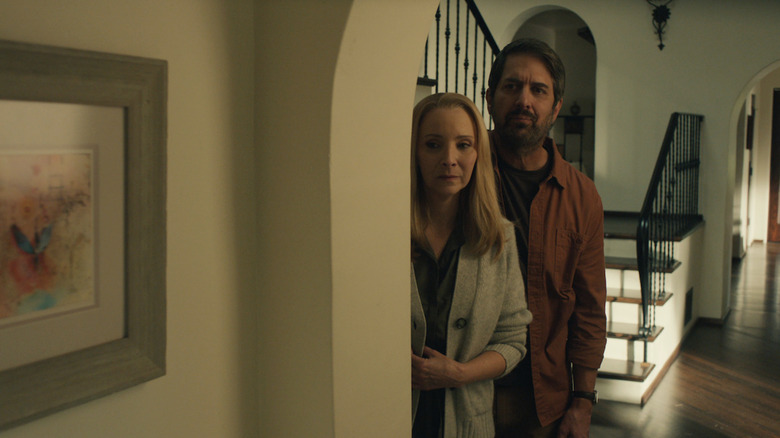 Ray Romano's Paul and Lisa Kudrow's Lydia stand together in the hallway of the house, looking down the hall in the film 