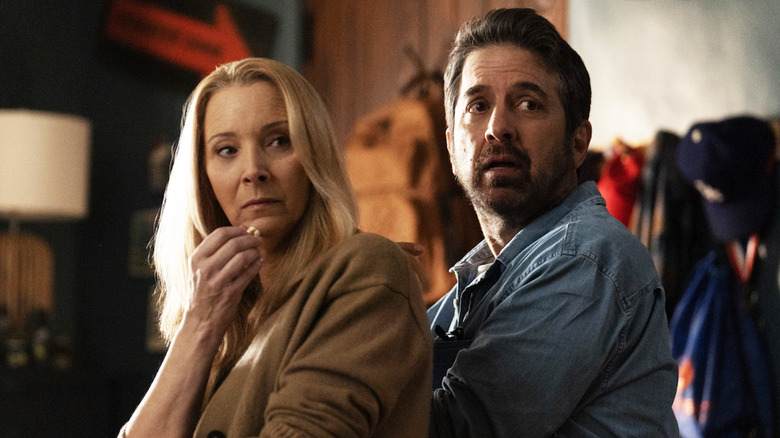 Ray Romano's Paul and Lisa Kudrow's Lydia sit together and look over their shoulders in the film 