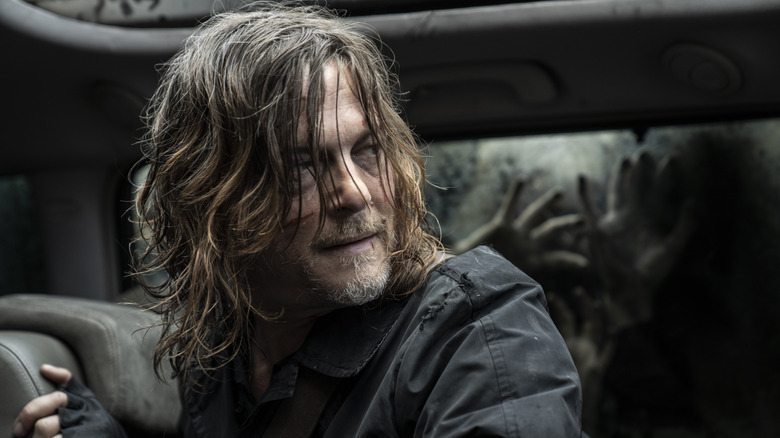 Daryl Dixon looking startled while hiding from Walkers inside a car in The Walking Dead: Daryl Dixon