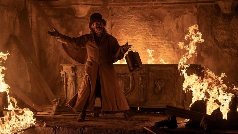 Willem Dafoe as Prof. Albin Eberhart Von Franz laughing while surrounded by flames in Nosferatu