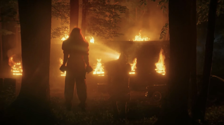 Bill Skarsgård's Pennywise reveals the Deadlights to Madeline Stowe's Ingrid Kersh as they stand outside in the woods in It Welcome to Derry