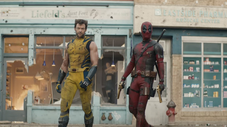 Deadpool & Wolverine walking in front of Liefeld's Just Feet storefront