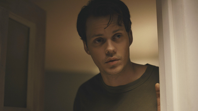 Bill Skarsgard as Keith standing in the doorway in Barbarian