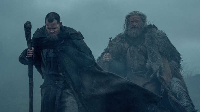 Bill Skarsgard as Little John and Hugh Jackman as Robin Hood walking in the fog in The Death of Robin Hood