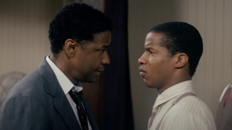 Denzel Washington as Professor Melvin Tolson and Nate Parker as Henry Lowe square off, looking profile at one another in The Great Debaters