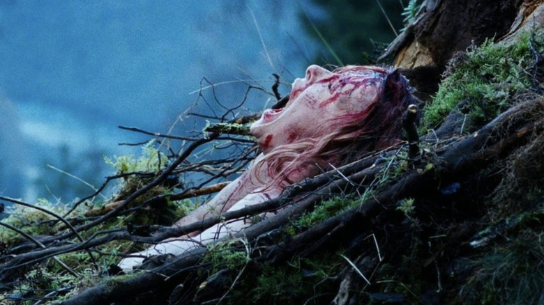 The Descent - Sarah gasping as she climbs out of cavern from tree trunk