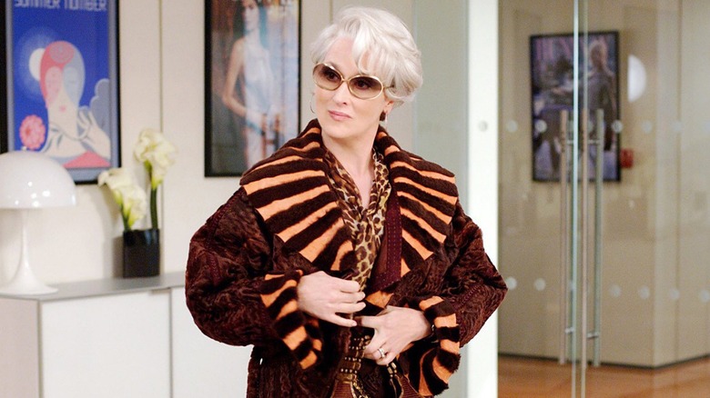 Miranda in a coat holding her handbag in The Devil Wears Prada