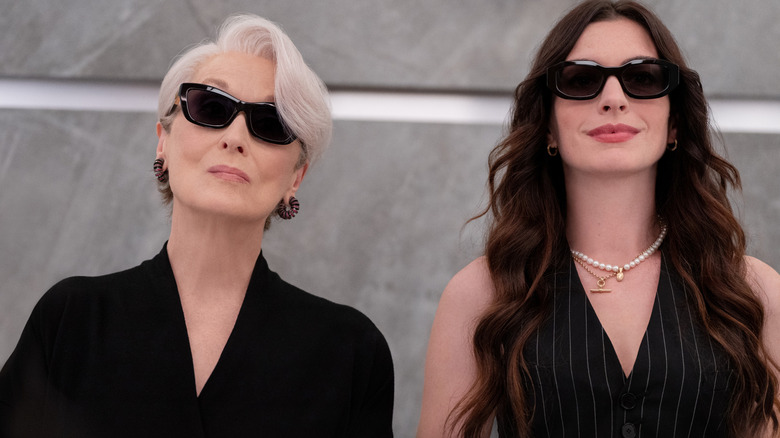 Meryl Streep as Miranda Priestly and Anne Hathaway as Andy Sachs wearing sunglasses and standing next to each other in The Devil Wears Prada 2
