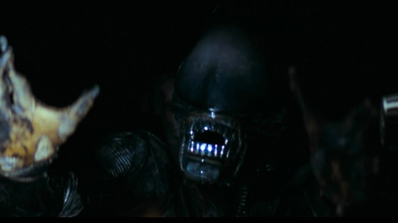 Xenomorph emerging from shadows