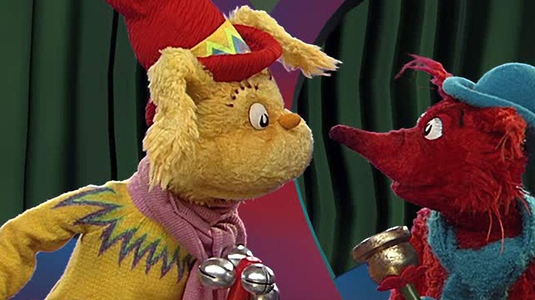 Two animals dolls look down at the aggregate world of Dr. Seus.