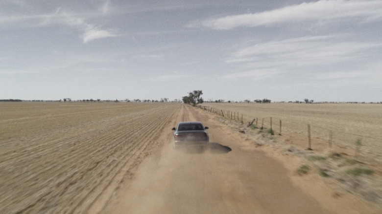A car drives through a dusty plain in The Dry
