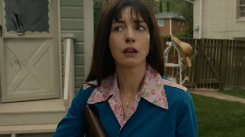 Anne Hathaway as Denise standing in the backyard tearing up in The End of Oak Street