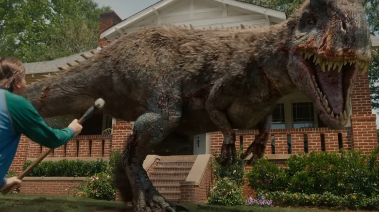 Ewan McGregor as Greg Platt getting ready to fighht an allosaurus with a hammer in The End of Oak Street