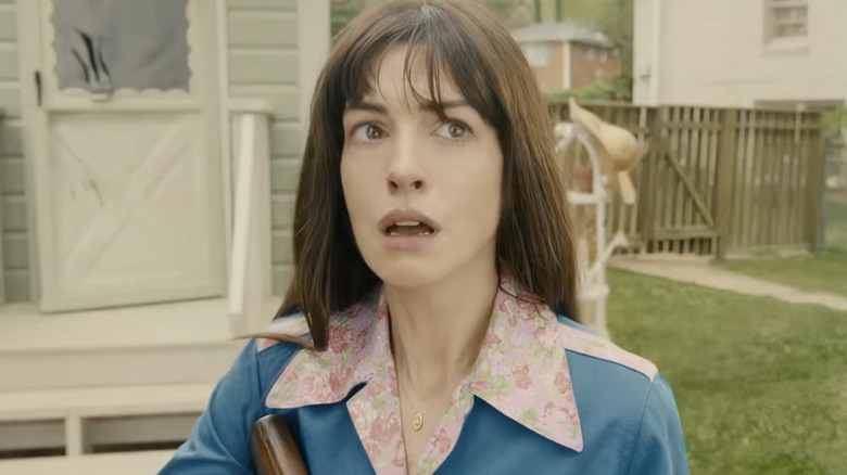 Anne Hathaway as Denise standing in the backyard tearing up in The End of Oak Street