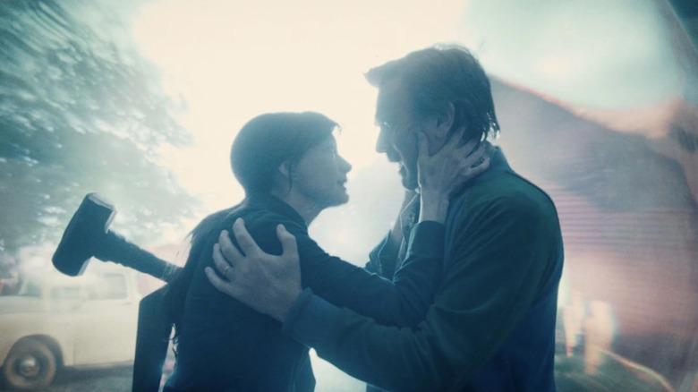 Denise (Anne Hathaway) and Greg (Ewan McGregor) embrace in front of a wormhole portal in The End of Oak Street