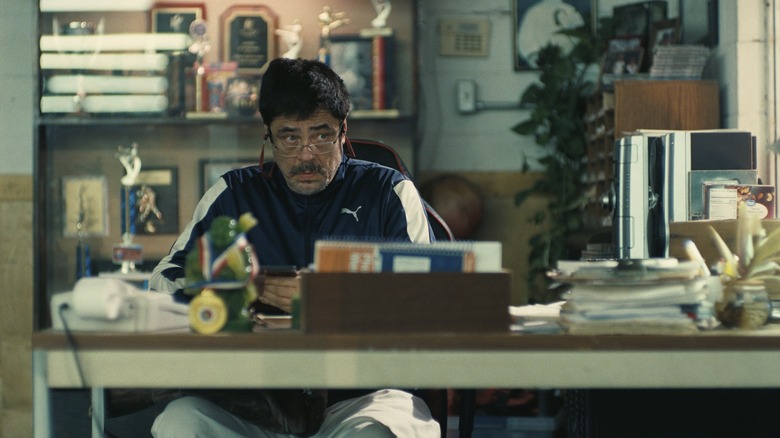 Sensei St. Carlos looking up from his desk in surprise in One Battle After Another