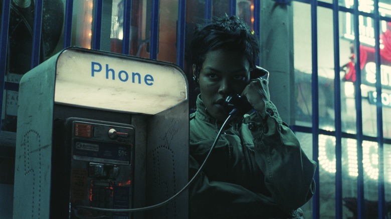 Perfidia Beverly Hills talking on a payphone in One Battle After Another