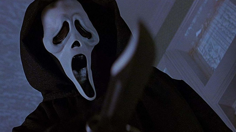 Ghostface toys with a victim in Scream (1996)