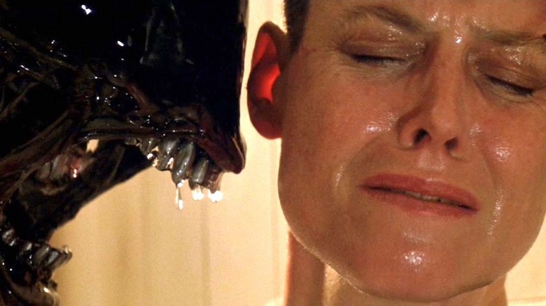 A Xenomorph snarls at Sigourney Weaver as Ellen Ripley in Alien 3