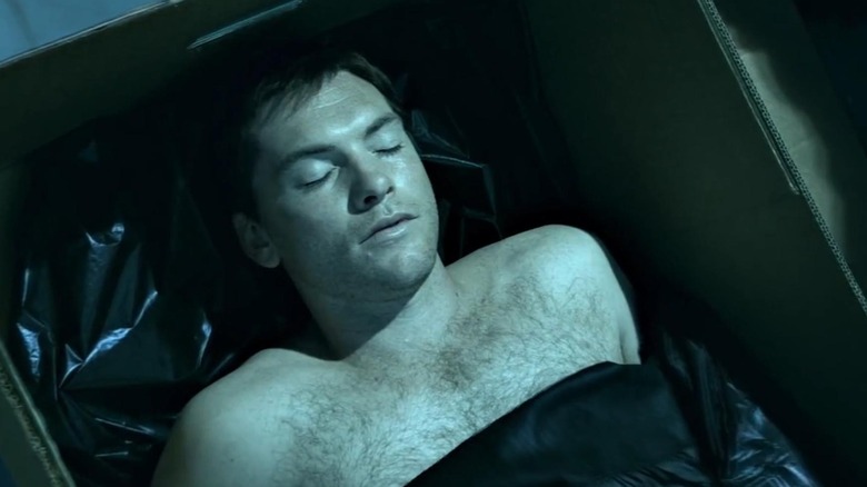 Sam Worthington as Tom Sully lies dead in a box in Avatar